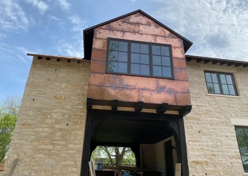 Copper metal panel facade on a stone building for Metal Roof Coating in Cibolo
