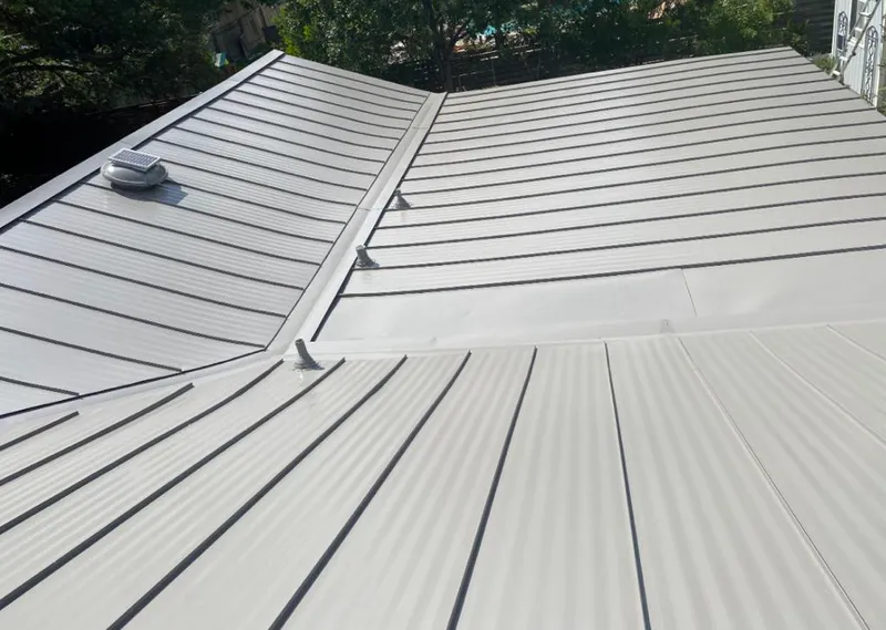 Solar attic fan installed on a metal roof for Roof Ventilation in Cibolo